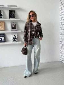 Full body look with plaid shirt, white t-shirt, wide leg jeans and brown leather handbag