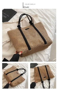 Detail view of khaki woven tote bag with black rope handles on white textured background