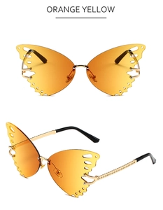 Detail of butterfly sunglasses with orange gradient lenses and gold chain temples