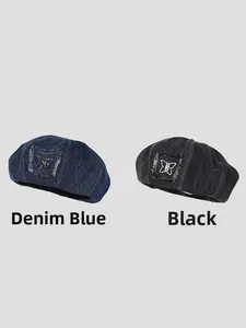 Close-up of denim beret hats featuring butterfly patches and frayed edge detailing