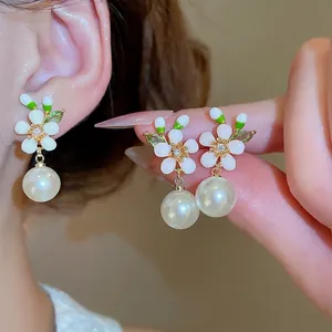Elegante 18k vergoldete Blumenohrringe mit weißen Perlen und grünen Blattakzenten