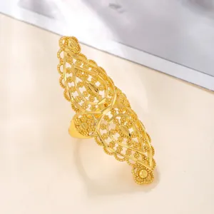 Detail of gold hollowed ring with intricate middle eastern floral engravings