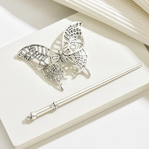 Close-up of a silver hollow butterfly hair pin with delicate metalwork detail