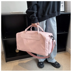 Pink large sports travel bag with double handles and adjustable shoulder strap detail