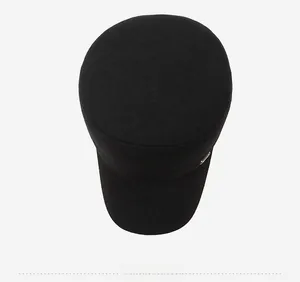 Top view of a black flat top winter military cap showing textured fabric and metal detail