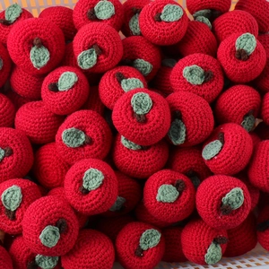 Handmade red crochet apple keychain charms with green leaf and brown stem detail
