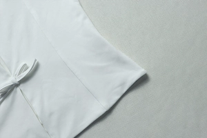 Détails de couture et ruban élégant sur cet ensemble jupe blanche deux pièces de fête