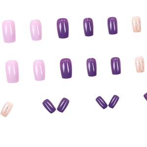 Short square press-on nails in purple, pink, and silver glitter finishes on white background