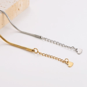 Minimalist gold and silver snake chain bracelets with elegant heart pendants and extensions