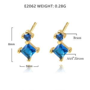 Detail view of gold star earrings with blue zircon stones and size specifications