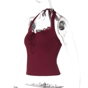Detail of burgundy lace trim and ribbon bow on backless halter top neckline