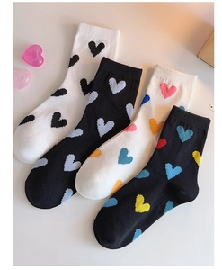 Detailed view of four pairs of heart-patterned mid-calf cotton socks in varied colors