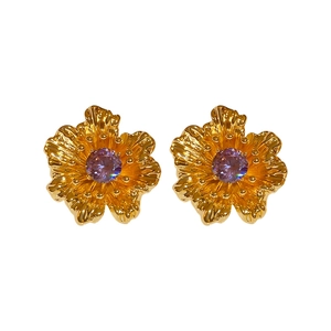 Vintage gold-plated flower earrings with purple zircon stones on a clean white background