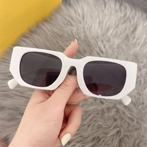 Detail of retro square white sunglasses featuring thick frames and dark polarized lenses