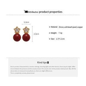 Detailed view of star-shaped zircon earrings with red pearls and exact dimensions