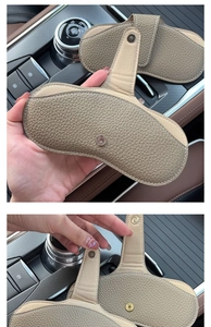 Detail of khaki pebbled leather car sun visor glasses clip with magnetic closure