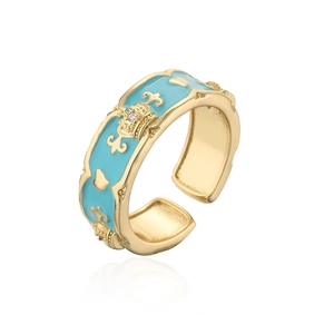 Detail of blue enamel 18K gold plated crown ring with zircon and iris flower motif