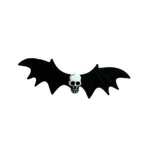 Halloween goth hair clip with black bat wings and white resin skull on white background