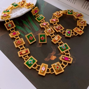 Detail showing vintage baroque jewelry set with enamel and colorful rhinestones