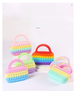 Rainbow silicone Pop it handbags in various colors featuring heart-shaped bubbles for stress relief