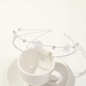Detailed view of elegant silver leaf bridal headband with sparkling rhinestones