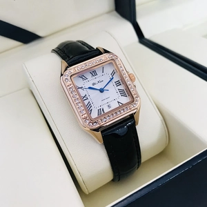Detail of rose gold square watch with crystal bezel and black leather strap on display