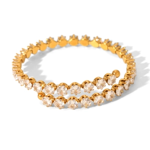 Luxurious gold double spiral bangle featuring sparkling white zircon stones on white background