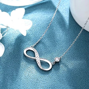 Detailed macro shot of infinity symbol pendant necklace with sparkling cubic zirconia accents