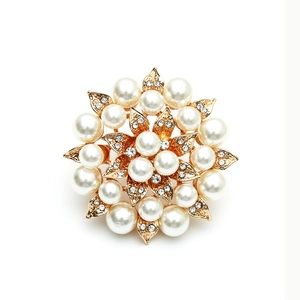 Elegant gold flower ring with inlaid pearls and rhinestones shown from a top-down view