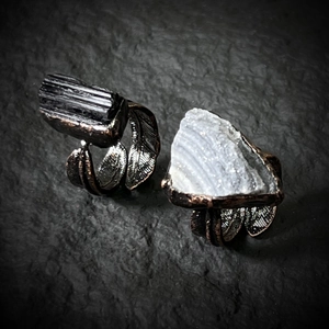 Detail of vintage bronze feather rings with black tourmaline and white crystal druzy