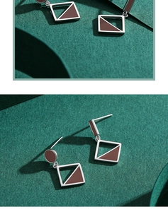 Detail of S925 silver irregular earrings with red-brown enamel inlay and hollow design