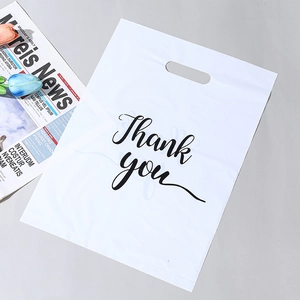 Detailed view of white plastic shopping bag with black Thank You print and handle