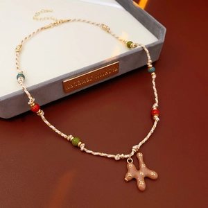 Detailed macro view of woven cord necklace with colorful beads and star pendant