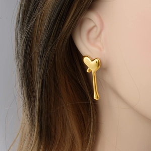 Elegant 18k gold plated 304 stainless steel heart tassel earrings worn by a model