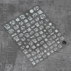 Detail of 5D white embossed nail stickers with Lucky Cat motifs and snowflake designs