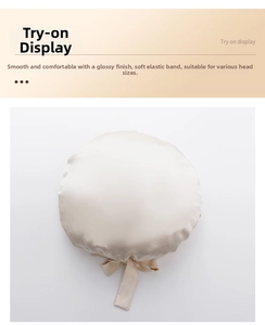 Detail of champagne satin sleep cap showing smooth silk texture and soft elastic bow tie