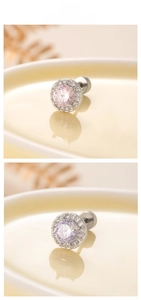 Detailed macro view of round pink and purple cubic zirconia stud earrings with halo setting