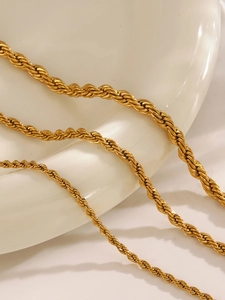 Macro shot of gold-plated stainless steel rope chains in three distinct thicknesses