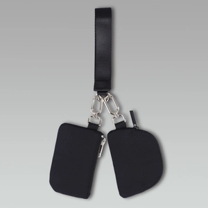 Close-up of black nylon wristlet bag set with metallic zippers and swivel hooks