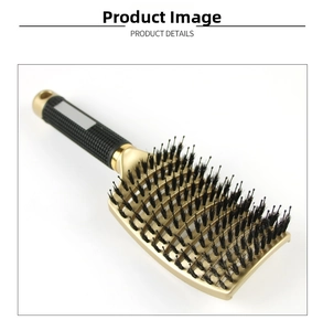 Detail of golden curved vented hairbrush with black non-slip handle for hair styling