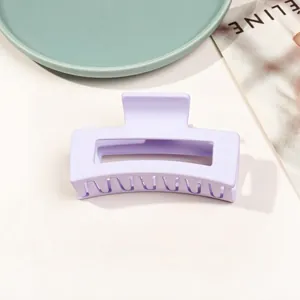 Macro view of lavender purple matte hair claw clip with rectangular cutout and sturdy teeth