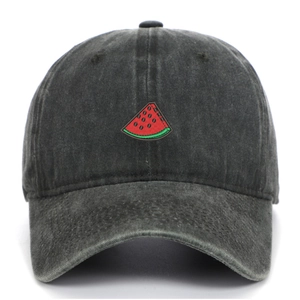 Close-up of embroidered watermelon slice on washed grey distressed cotton baseball cap