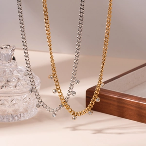Chic 18K gold and silver Cuban chain necklaces with round zircon pendants shown on a tray