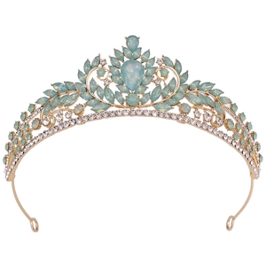 Detailed macro view of golden leaf crown with opal blue gems and sparkling crystals