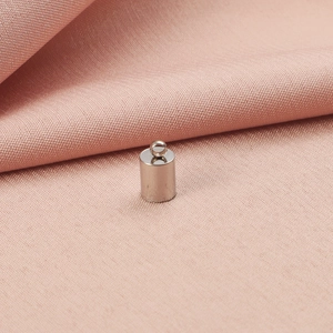 Macro shot of silver cylindrical metal cord end cap with ring for DIY jewelry making