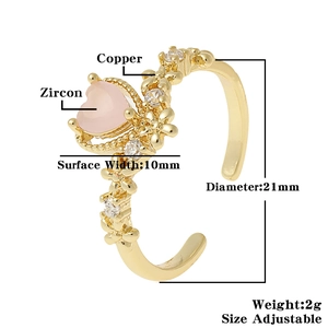 Detail of adjustable gold ring with pink heart zircon and small floral patterns