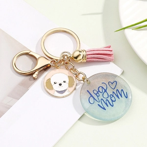 Detail of Dog Mom keychain with pink tassel, resin charm, and cute puppy pendant