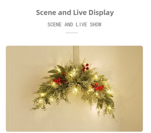 Detail of Christmas PE red berry door wreath with warm LED lights and pine leaves