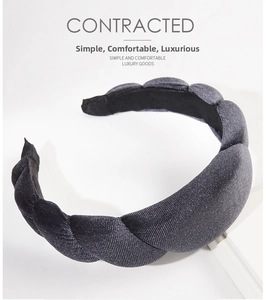 Close-up of dark grey thick twisted velvet headband with shimmering woven texture