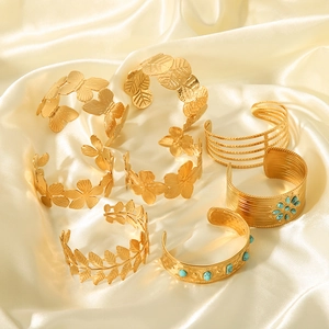 Gold-plated stainless steel cuff bracelets set with floral designs and turquoise stones